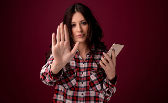 Woman holding her hand out to show stop.