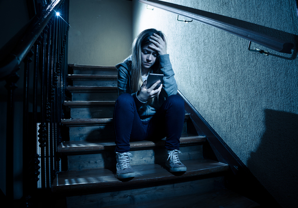 Teen sitting on steps.