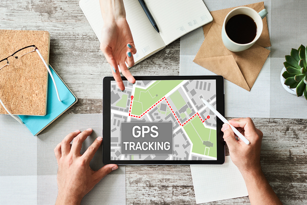 Desktop with a tablet showing a GPS location.