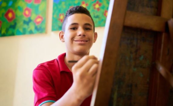 Teen painting on a canvas